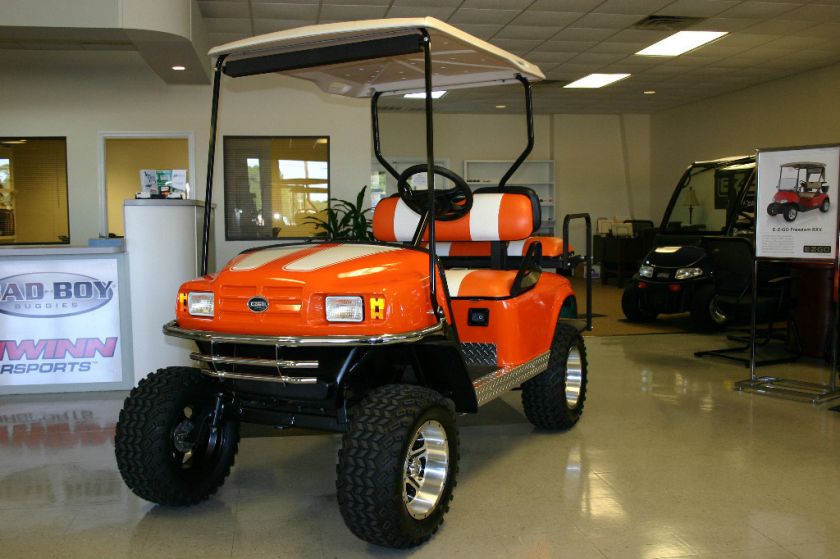 EZGO CUSTOM ELECTRIC LIFTED ORANGE & WHITE NEW TROJAN BATTERIES  